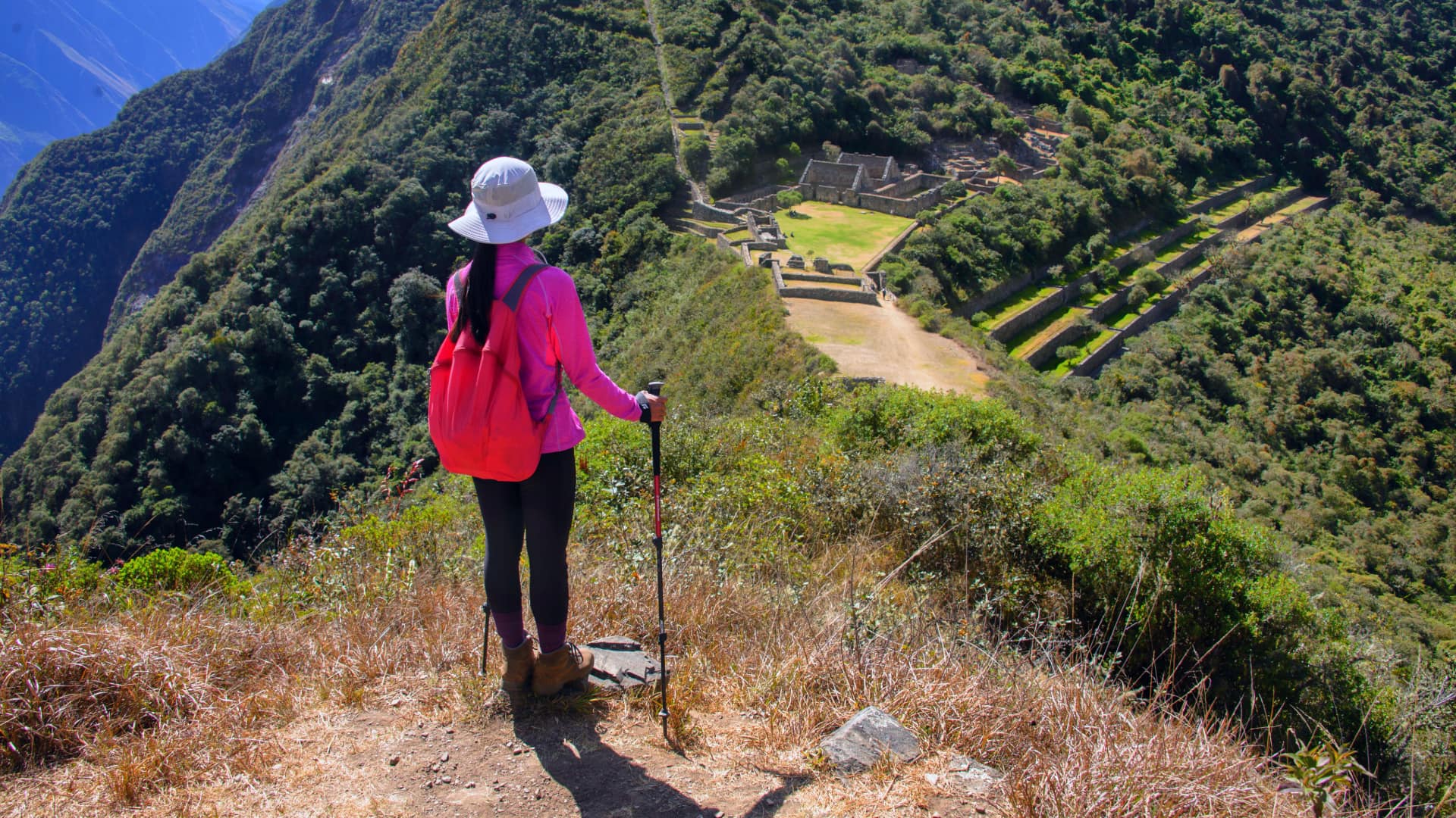 A trekker on a mountain trail in the Andes, showcasing the rugged terrain typical of the Choquequirao Trek.